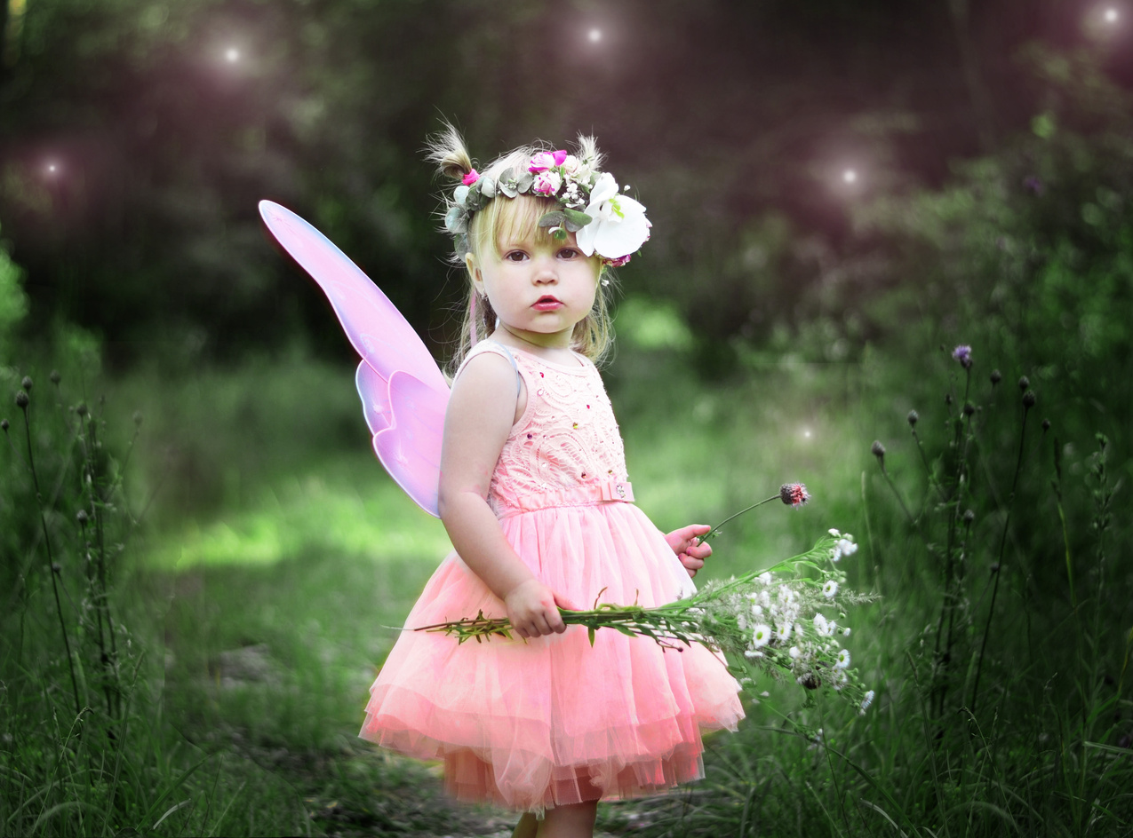 Little Girl Dressed As A Fairy In A garden